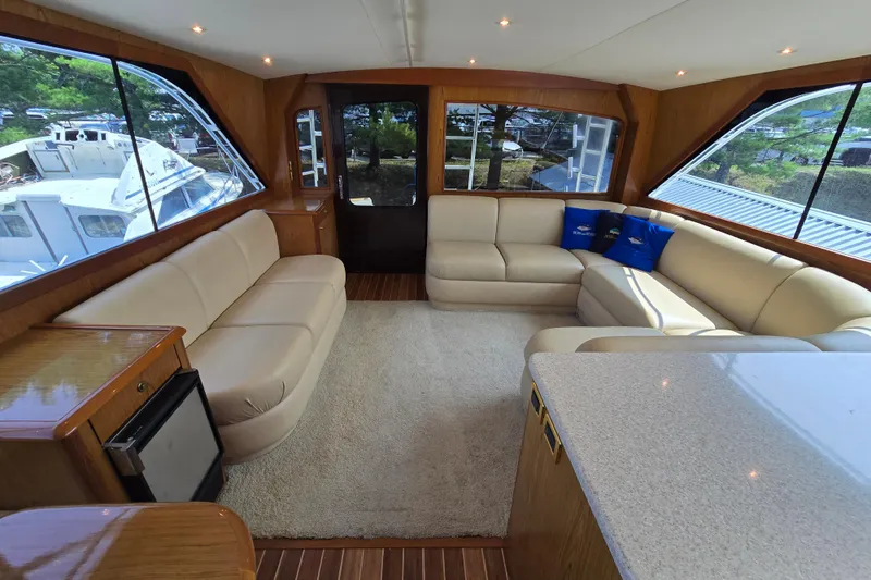 Slide: The Image of Luxurious interior of 1986 Ocean Yachts 55 Super Sport with beige seating and large windows. - 15