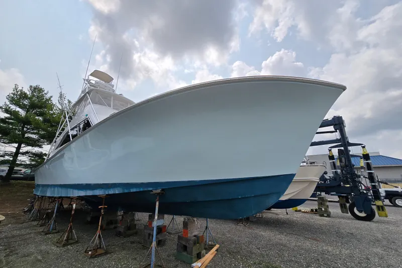 Slide: The Image of 1986 Ocean Yachts 55 Super Sport boat on stands under cloudy sky. - 4