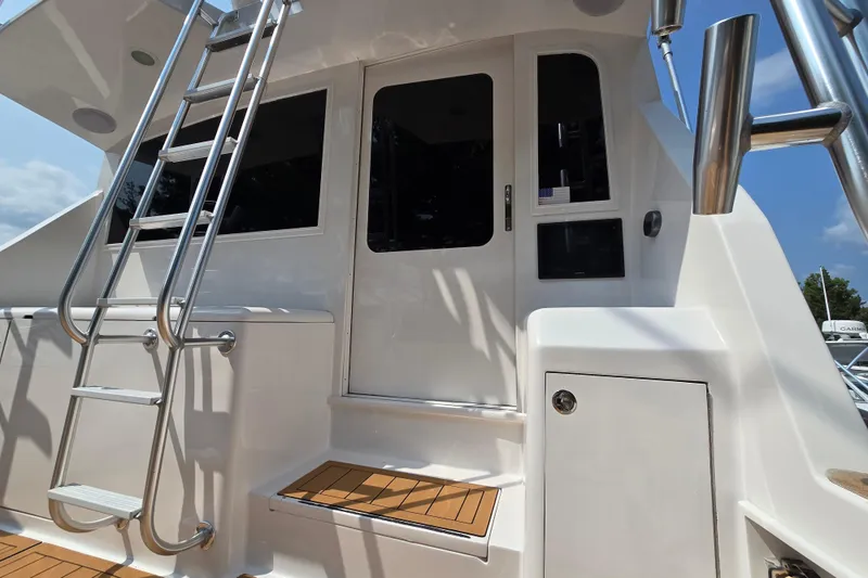 Slide: The Image of 1986 Ocean Yachts 55 Super Sport yacht with ladder and teak deck details. - 51