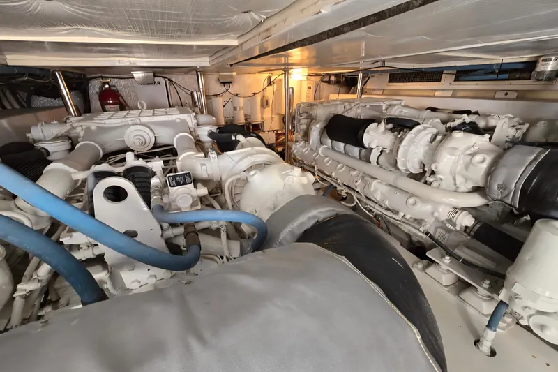 Slide: The Image of Engine room of 1986 Ocean Yachts 55 Super Sport, showcasing dual engines and mechanical components. - 56
