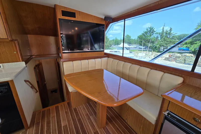 Slide: The Image of Interior of 1986 Ocean Yachts 55 Super Sport with dining area and large window view. - 18