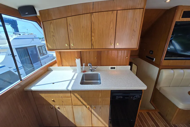 Slide: The Image of Interior of 1986 Ocean Yachts 55 Super Sport, featuring a compact kitchen area. - 20