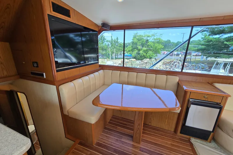 Slide: The Image of Luxurious interior of 1986 Ocean Yachts 55 Super Sport with dining area and large windows. - 21