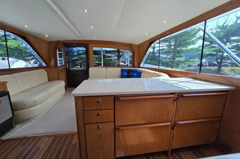 Slide: The Image of Luxurious interior of 1986 Ocean Yachts 55 Super Sport with elegant wood cabinetry and seating. - 24