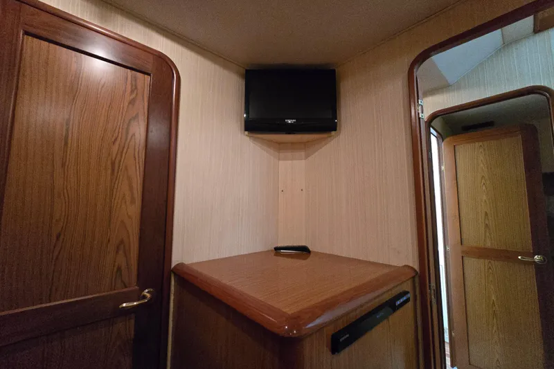 Slide: The Image of Interior of 1986 Ocean Yachts 55 Super Sport with wood paneling and mounted TV. - 31