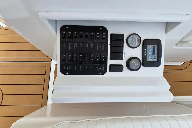 Slide: The Image of Control panel on 1986 Ocean Yachts 55 Super Sport, featuring switches and gauges. - 42