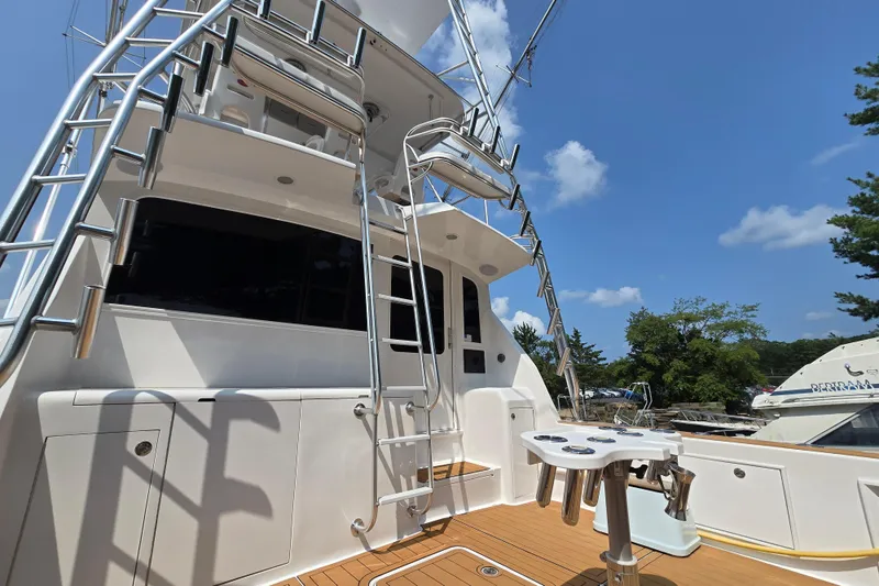 Slide: The Image of 1986 Ocean Yachts 55 Super Sport yacht with ladder and fishing station under clear sky. - 48