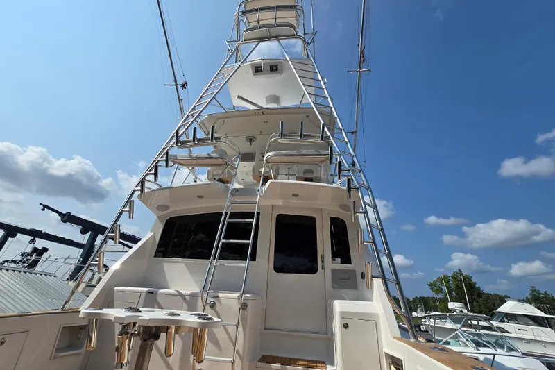 Slide: The Image of 1986 Ocean Yachts 55 Super Sport, rear view with tower, under clear blue sky. - 52