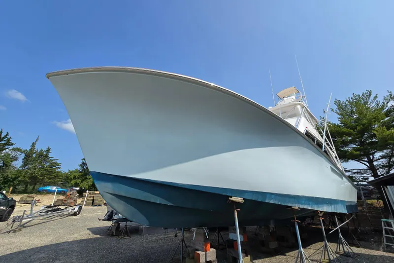 Slide: The Image of 1986 Ocean Yachts 55 Super Sport on dry dock, clear sky background. - 9
