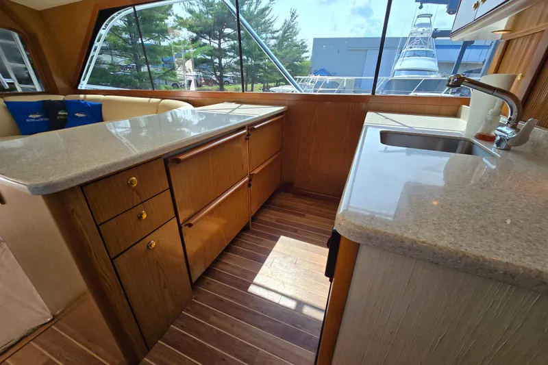 Slide: The Image of Interior of 1986 Ocean Yachts 55 Super Sport with wood cabinetry and countertops. - 17