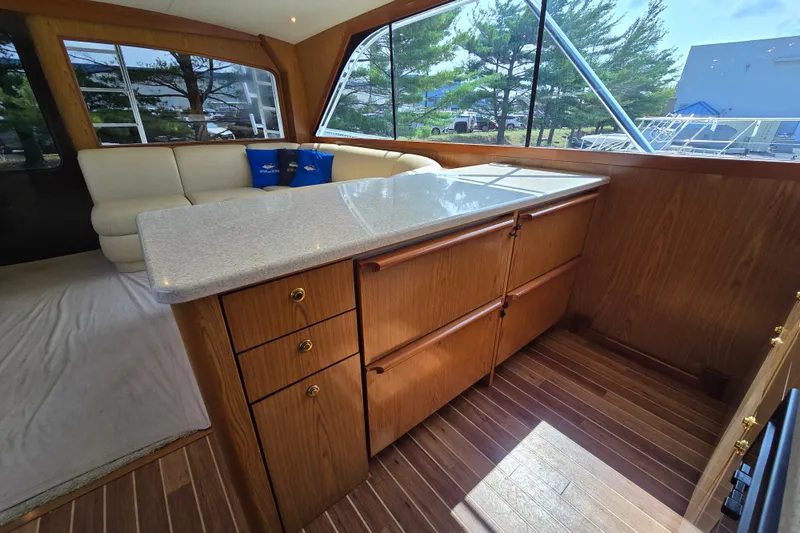 Slide: The Image of Interior of 1986 Ocean Yachts 55 Super Sport with wood cabinetry and seating area. - 23
