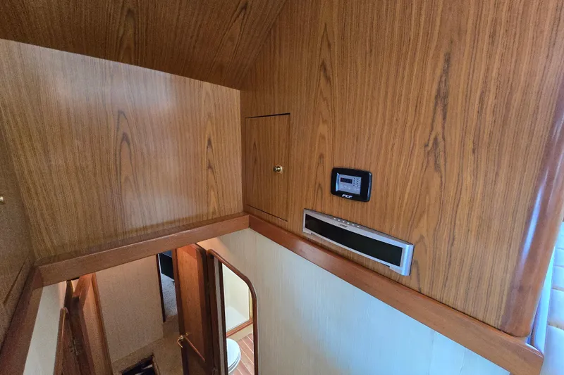 Slide: The Image of Interior of 1986 Ocean Yachts 55 Super Sport with wood paneling and control panel. - 25
