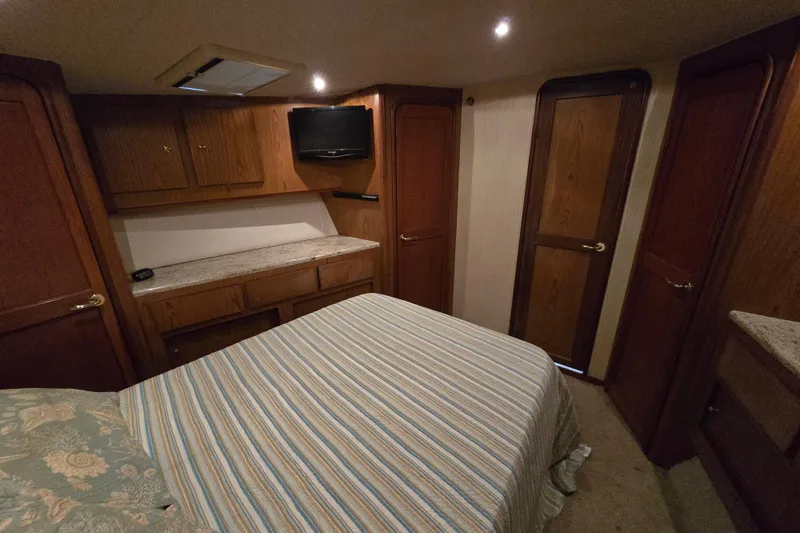 Slide: The Image of Interior of 1986 Ocean Yachts 55 Super Sport with cozy bedroom and wooden cabinetry. - 34