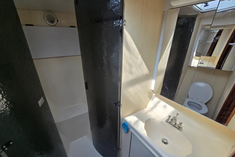 Slide: The Image of Bathroom interior of 1986 Ocean Yachts 55 Super Sport, featuring shower and sink. - 36