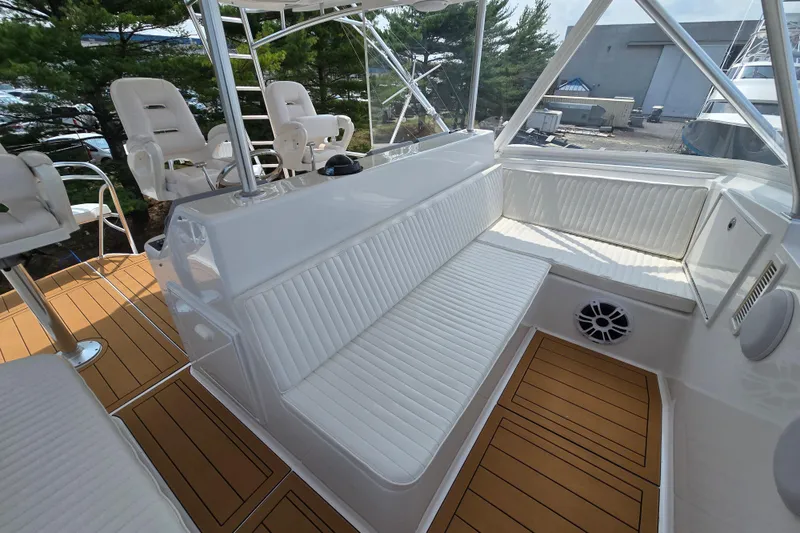 Slide: The Image of 1986 Ocean Yachts 55 Super Sport interior with white seating and teak flooring. - 47