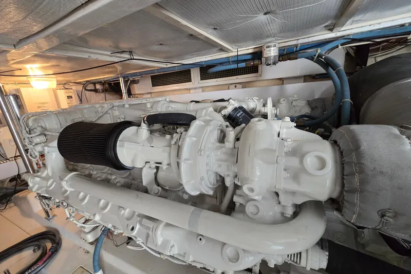 Slide: The Image of Engine room of 1986 Ocean Yachts 55 Super Sport, showcasing a well-maintained marine engine. - 53
