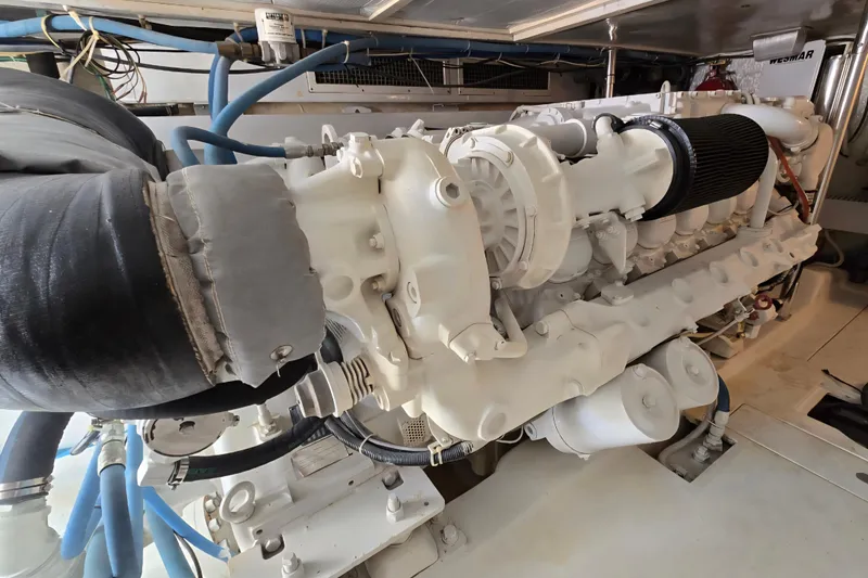 Slide: The Image of Engine room of 1986 Ocean Yachts 55 Super Sport, showcasing detailed machinery and components. - 57