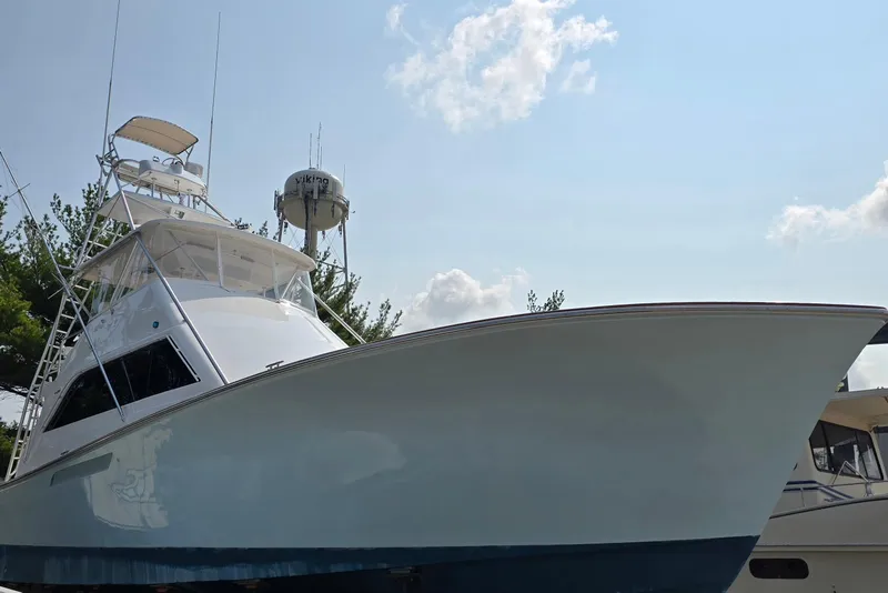 Slide: The Image of 1986 Ocean Yachts 55 Super Sport boat under clear sky, showcasing sleek design. - 8