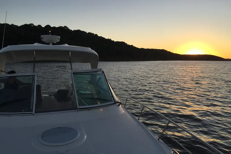 Slide: The Image of 2006 Cruisers Yachts 420 Express on water at sunset, scenic view. - 14