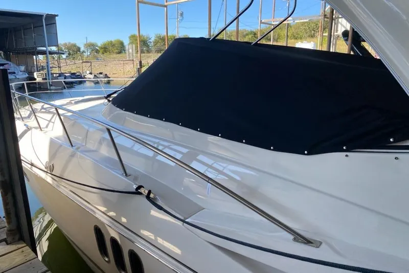 Slide: The Image of 2006 Cruisers Yachts 420 Express docked, featuring sleek design and covered cockpit. - 20