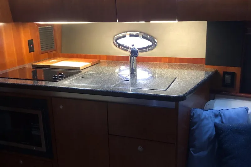 Slide: The Image of 2006 Cruisers Yachts 420 Express kitchen with granite countertop and modern fixtures. - 22