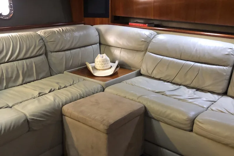 Slide: The Image of Luxurious leather seating in 2006 Cruisers Yachts 420 Express interior with cowboy hat decor. - 23