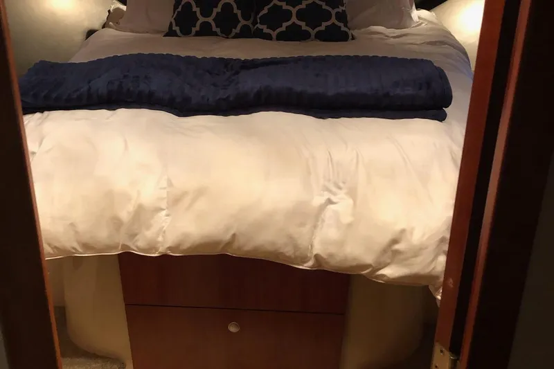 Slide: The Image of Cozy bedroom interior of 2006 Cruisers Yachts 420 Express with plush bedding. - 25