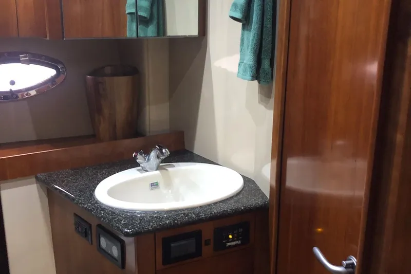 Slide: The Image of Luxurious bathroom interior of 2006 Cruisers Yachts 420 Express with modern sink and wooden accents. - 27