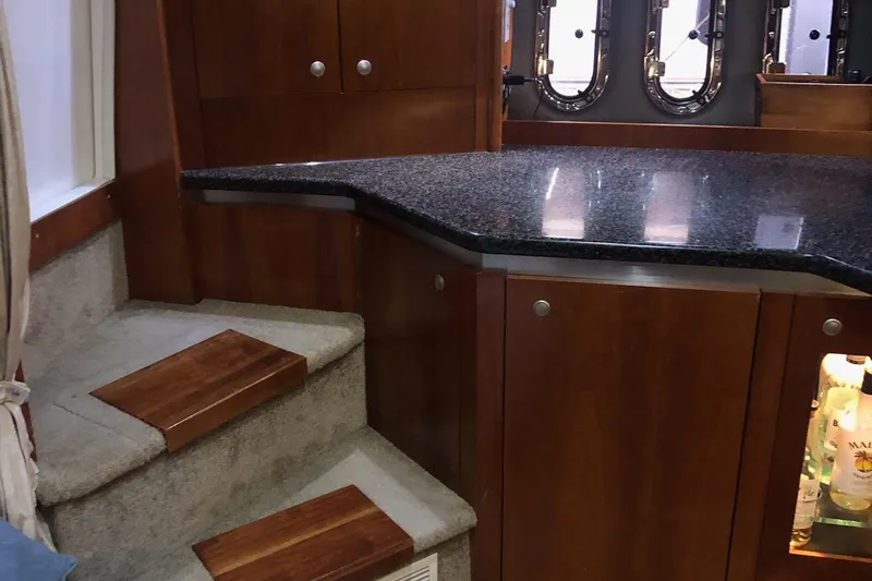 Slide: The Image of Interior of 2006 Cruisers Yachts 420 Express with wooden cabinetry and granite countertop. - 28