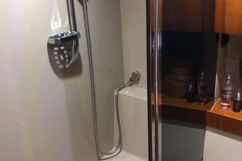 Slide: The Image of Shower area in 2006 Cruisers Yachts 420 Express, featuring modern fixtures and storage shelves. - 30
