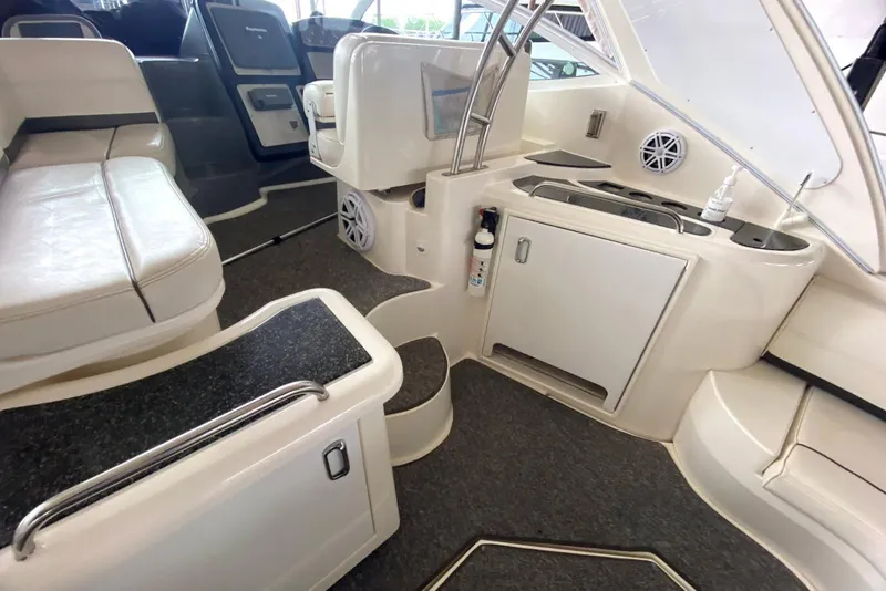 Slide: The Image of Interior of 2006 Cruisers Yachts 420 Express, featuring seating and kitchenette area. - 34