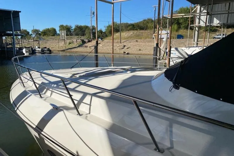 Slide: The Image of 2006 Cruisers Yachts 420 Express docked, showcasing sleek design and spacious deck. - 37