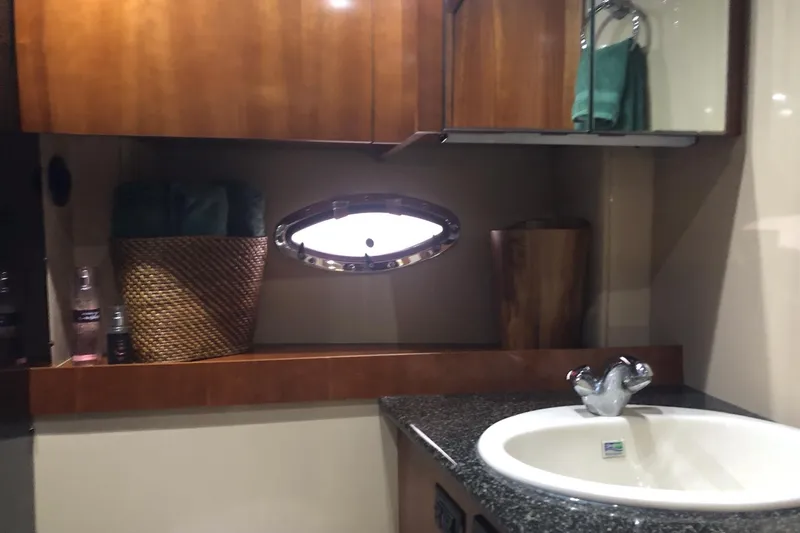 Slide: The Image of Luxurious bathroom interior of 2006 Cruisers Yachts 420 Express with sink and porthole window. - 38