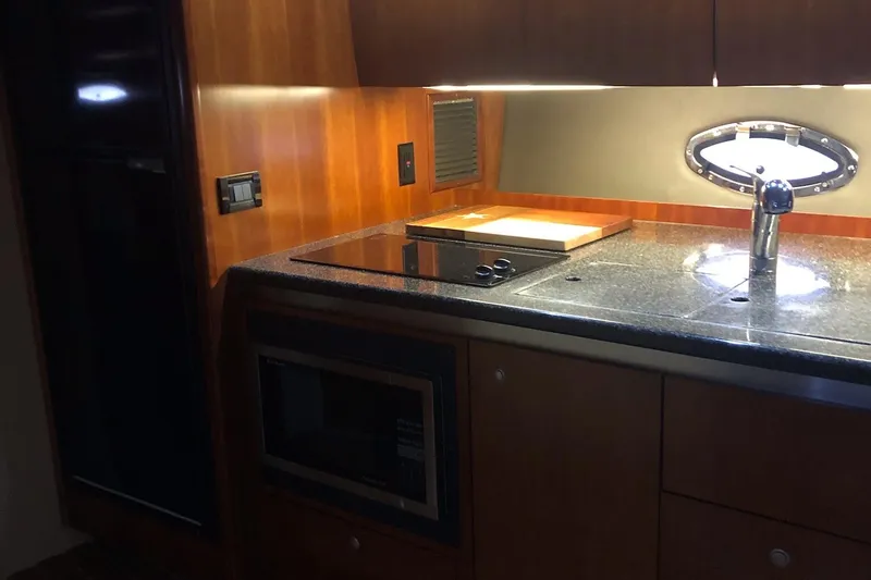 Slide: The Image of 2006 Cruisers Yachts 420 Express kitchen with modern appliances and sleek wood cabinetry. - 40