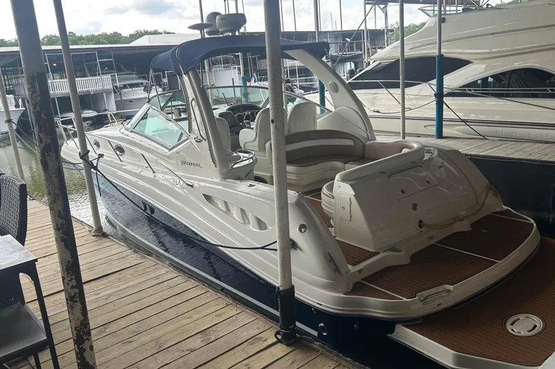The Image of 2005 Sea Ray 340 Sundancer docked at marina, featuring sleek design and spacious seating. - 0
