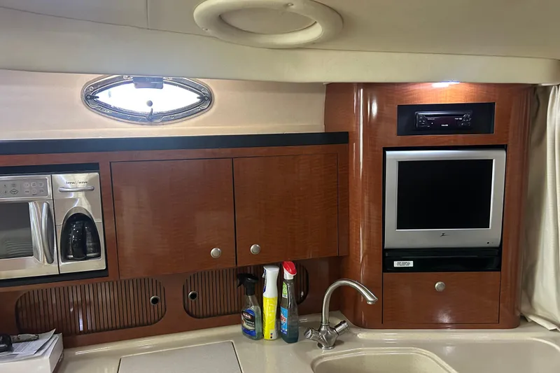 Slide: The Image of 2005 Sea Ray 340 Sundancer cabin with microwave, TV, and sink. - 12