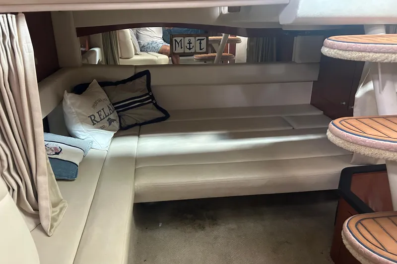Slide: The Image of Interior of 2005 Sea Ray 340 Sundancer with cozy seating and decorative pillows. - 18