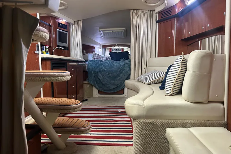 Slide: The Image of Interior of 2005 Sea Ray 340 Sundancer yacht with cozy seating and striped rug. - 19