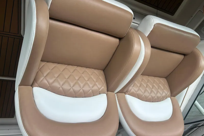 Slide: The Image of Luxurious tan and white leather seats on a 2005 Sea Ray 340 Sundancer boat. - 23