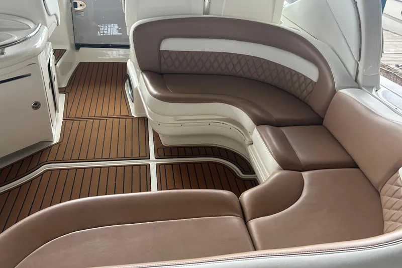 Slide: The Image of Luxurious interior seating of 2005 Sea Ray 340 Sundancer with brown leather and wood flooring. - 27