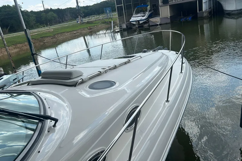Slide: The Image of 2005 Sea Ray 340 Sundancer yacht docked at a marina, reflecting on calm water. - 28