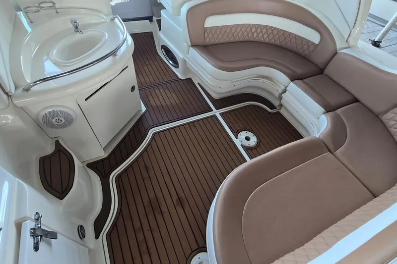 Slide: The Image of 2005 Sea Ray 340 Sundancer interior with brown seating and wood-style flooring. - 30