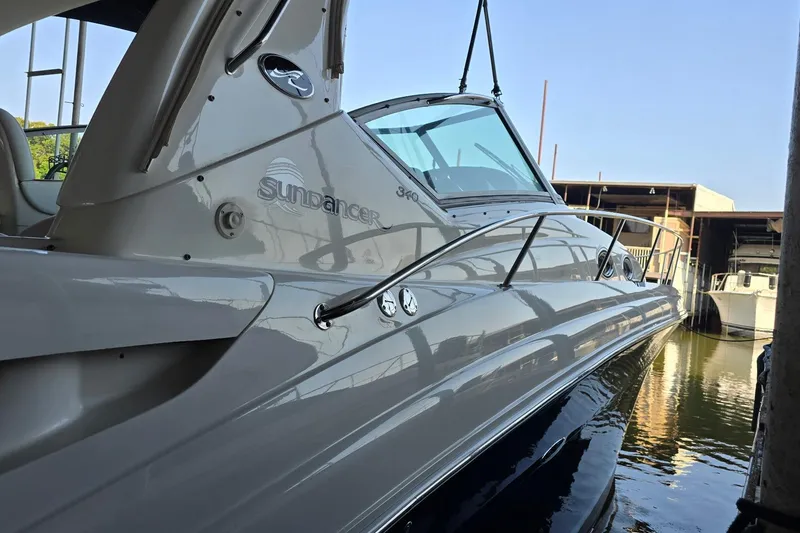 Slide: The Image of 2005 Sea Ray 340 Sundancer yacht docked, showcasing sleek design and polished exterior. - 33