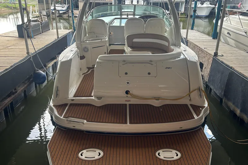 Slide: The Image of 2005 Sea Ray 340 Sundancer docked, showcasing spacious deck and elegant design. - 4
