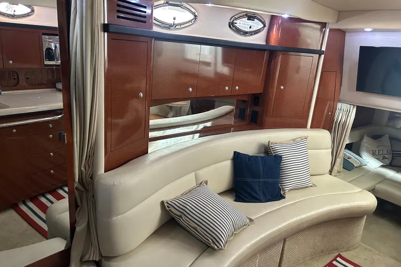 Slide: The Image of Luxurious interior of 2005 Sea Ray 340 Sundancer with plush seating and elegant wood cabinetry. - 9