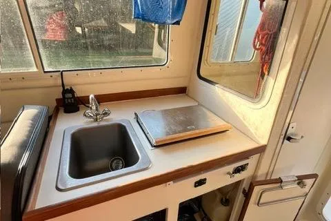 Slide: The Image of 2007 C-Dory Tomcat 255 Pilothouse interior with sink and counter space. - 11