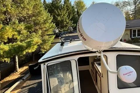 Slide: The Image of 2007 C-Dory Tomcat 255 Pilothouse with radar, surrounded by trees. - 14