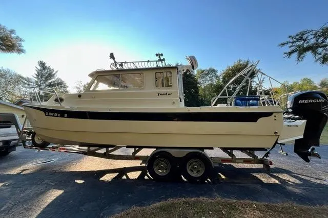 Slide: The Image of 2007 C-Dory Tomcat 255 Pilothouse boat on trailer, side view, outdoors. - 15