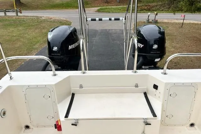 Slide: The Image of 2007 C-Dory Tomcat 255 Pilothouse with dual Mercury outboard engines, rear view. - 6