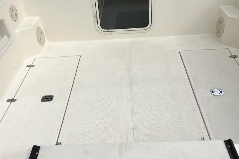 Slide: The Image of 2007 C-Dory Tomcat 255 Pilothouse deck with storage hatches and non-slip surface. - 7